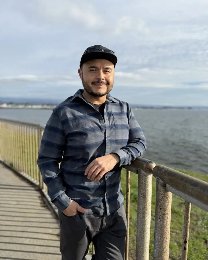 Fermin Cruz standing at a coastal railing